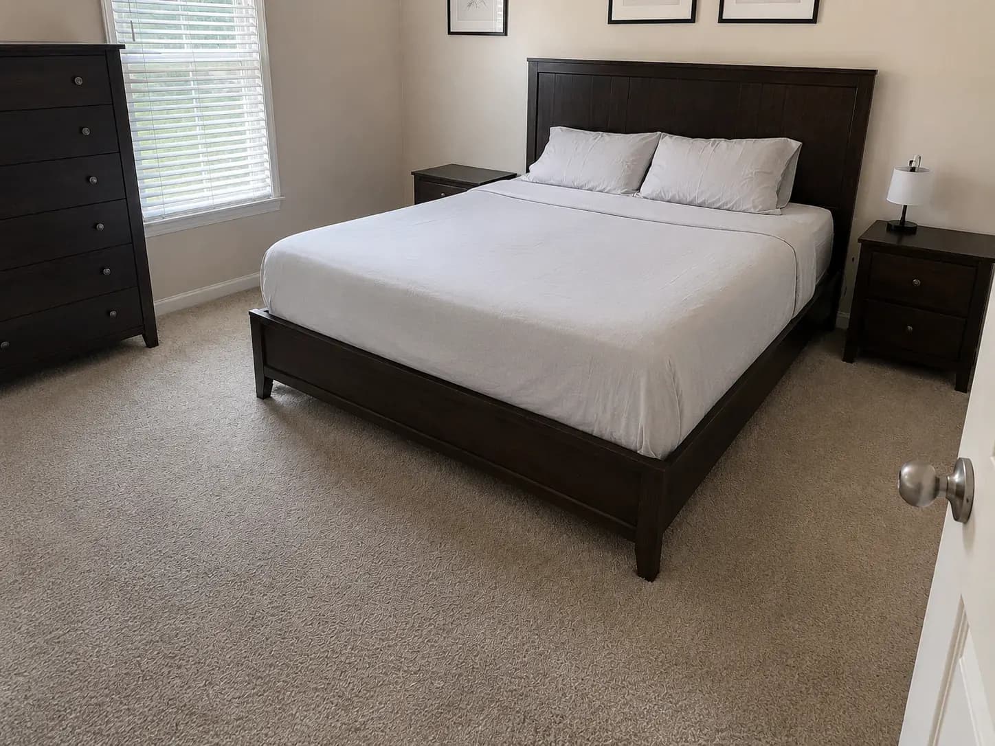 Bedroom in a Plano apartment with the bed made and the carpet vacuumed after a cleaning visit